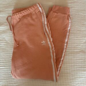 Light peach colored adidas joggers in XL